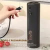 A hand is shown holding a USB-C cable, about to plug it into a black electric pepper grinder. The grinder has a clear window showing peppercorns. Text overlays describe its features. Náhľad obrázku produktu