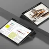 Two tablets are displayed on a gray surface, one showing a document with graphs and text, the other displaying a sketch of a building. Produktbild-Vorschau