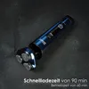 A blue electric shaver is placed on a dark, textured surface. Produktbild-Vorschau