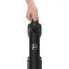 A hand holding the handle of a black Hoover vacuum cleaner. Produktbild-Vorschau