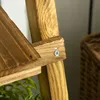 A close-up view of a wooden plant stand, showing a screw fastening two wooden pieces together. Produktbild-Vorschau
