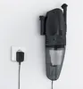 A handheld vacuum cleaner mounted on a wall, plugged into an electrical outlet. Produktbild-Vorschau
