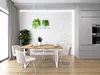 A modern dining room with a table and chairs, featuring a textured white wall and kitchen cabinets in the background. Produktbild-Vorschau