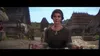 A woman stands in a medieval village setting, holding what appears to be reins. Produktbild-Vorschau