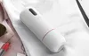 A white cylindrical product with black and red accents is placed on a white piece of fabric, possibly clothing. Náhled obrázku produktu