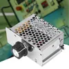 A close-up product shot of a voltage regulator with a knob, set against a blurred industrial background. Náhled obrázku produktu