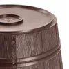A close-up view of the top and side of a brown barrel-shaped object, likely a Christmas tree stand. Voir les images du produit