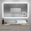 A bathroom vanity with a sink and a lighted mirror above it. The mirror has a frosted effect and a smaller inset mirror. There is a soap dispenser and a jar on the vanity. Produktbild-Vorschau