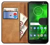 A book-style phone case with cards and cash inserted, next to a smartphone displaying the home screen. Náhľad obrázku produktu