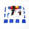A collection of tools for applying sealant, including a pneumatic caulking gun and various nozzles and applicators, laid out on a white background. Podgląd zdjęcia produktu