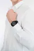 A man wearing a white dress shirt and a black watch. Podgląd zdjęcia produktu