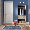 A room interior with a door, a wardrobe, a stool, and a rug. Podgląd zdjęcia produktu