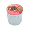 A clear glass jar with a pink lid featuring a bee and floral pattern. Podgląd zdjęcia produktu
