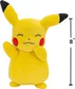 A yellow Pikachu plush toy is shown standing against a white background. A measurement scale indicating 8 inches is visible on the right side of the image. Náhled obrázku produktu
