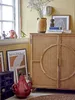 A collection of decorative items and artwork displayed in a room with yellow walls and a window. Produktbild-Vorschau