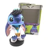 A Stitch figurine dressed as Elvis Presley sits in front of its packaging. Anteprima dell’immagine prodotto
