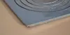A close-up view of a cast iron stove plate with concentric circles. Náhľad obrázku produktu
