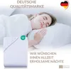A woman sleeping peacefully on a pillow, with a folded sheet in the foreground and marketing text. Produktbild-Vorschau