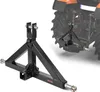 A black tractor hitch adapter is shown in the foreground, with a blurred tractor in the background. Náhľad obrázku produktu