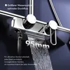 A close-up of a modern chrome shower faucet with water flowing out. Podgląd zdjęcia produktu