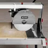 A close-up view of a tile saw with a large circular blade and a piece of tile on the cutting surface. Anteprima dell’immagine prodotto