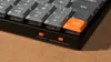 A close-up shot of a mechanical keyboard, focusing on the bottom edge and a few keys. Produktbild-Vorschau