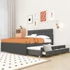 A bedroom scene featuring a tufted upholstered bed with an integrated trundle drawer and a wood nightstand. Náhled obrázku produktu