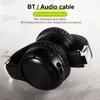 A pair of black over-ear headphones with silver accents, shown from a side angle on a textured light gray surface. Produktbild-Vorschau