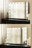 A vanity mirror with lights on a dresser. Produktbild-Vorschau