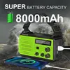 A green and black emergency radio is shown in the foreground, with a smartphone charging from it. The background depicts a stormy sea with large waves. Produktbild-Vorschau