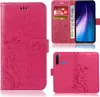 A collage of images showing a pink flip phone case with a floral and butterfly design, including a view of the inside with card slots and a phone inserted. Produktbild-Vorschau