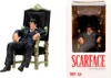 A product shot of a Tony Montana figurine from Scarface, seated in a throne, next to its packaging. Náhľad obrázku produktu