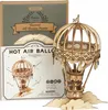 A 3D wooden puzzle of a hot air balloon is shown, with its packaging in the background. Anteprima dell’immagine prodotto