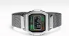 A silver digital watch with a mesh band is displayed against a white background. Voir les images du produit