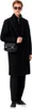 A man wearing a black coat and sunglasses, carrying a black bag. Anteprima dell’immagine prodotto