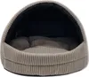 A close-up view of an open pet bed with a corduroy exterior and a soft interior. Produktbild-Vorschau