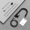A black kitchen faucet with its accessories and an instruction manual are laid out on a gray surface. Anteprima dell’immagine prodotto