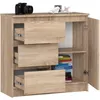 A wooden chest of drawers with an open cabinet on the right side, displaying books on a shelf. A camera and some decorative items are on top. Voir les images du produit