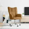 A brown velvet office chair is shown in a room with a floor lamp, a painting, and a TV stand. Náhľad obrázku produktu