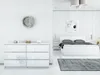 A modern bedroom with a white dresser and a white bed. Produktbild-Vorschau