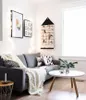 A cozy living room scene with a gray sofa, a white blanket, and decorative pillows. Podgląd zdjęcia produktu