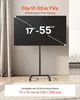 A black rolling TV stand holding a large flat-screen TV, displayed in a room with curtains and a window view. Produktbild-Vorschau