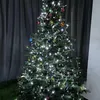 A decorated Christmas tree with white lights and ornaments. Produktbild-Vorschau