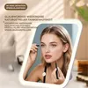 A woman is applying makeup in front of an LED makeup mirror. Produktbild-Vorschau