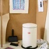 A Wesco trash can is shown in a creative workspace setting, with art supplies and a corkboard in the background. Náhled obrázku produktu