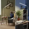 A split image showing a floor lamp in two different settings: one in a living room with a chair and side table, and another in a study or bedroom with a desk and bookshelf. Anteprima dell’immagine prodotto