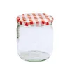 A clear studio shot of an empty glass jar with a red and white checkered lid. Produktbild-Vorschau