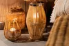 Several bamboo lanterns with candles inside are arranged on a floor. Náhled obrázku produktu