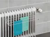 A radiator with a drying rack attached, holding two towels. Anteprima dell’immagine prodotto