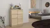 A modern bedroom with a dresser and a bed. Produktbild-Vorschau